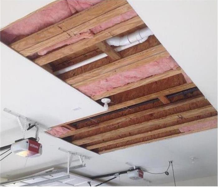 ceiling panels removed, showing insulation a PVC pipe