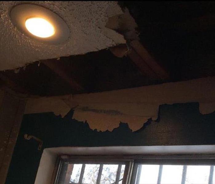 hanging debris from water in ceiling and wall, high hat light