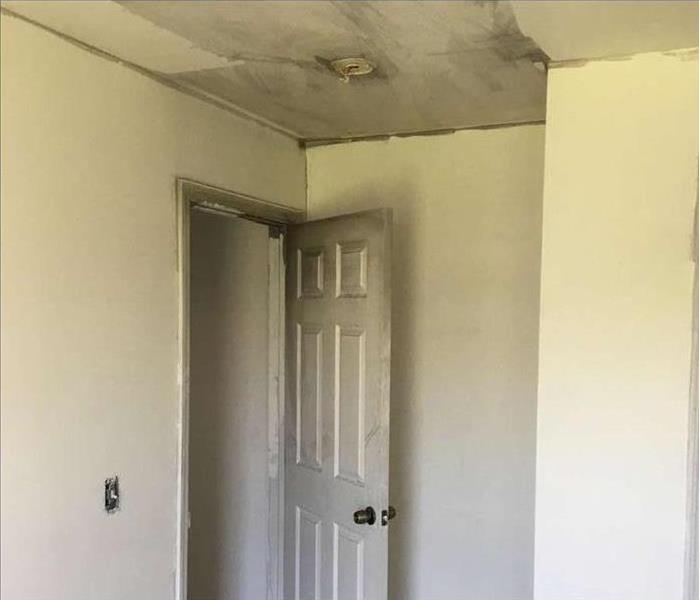 door, ceiling, and walls with black soot deposits